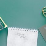 A top-down view of a shopping cart, list, card, and bag on a green background.